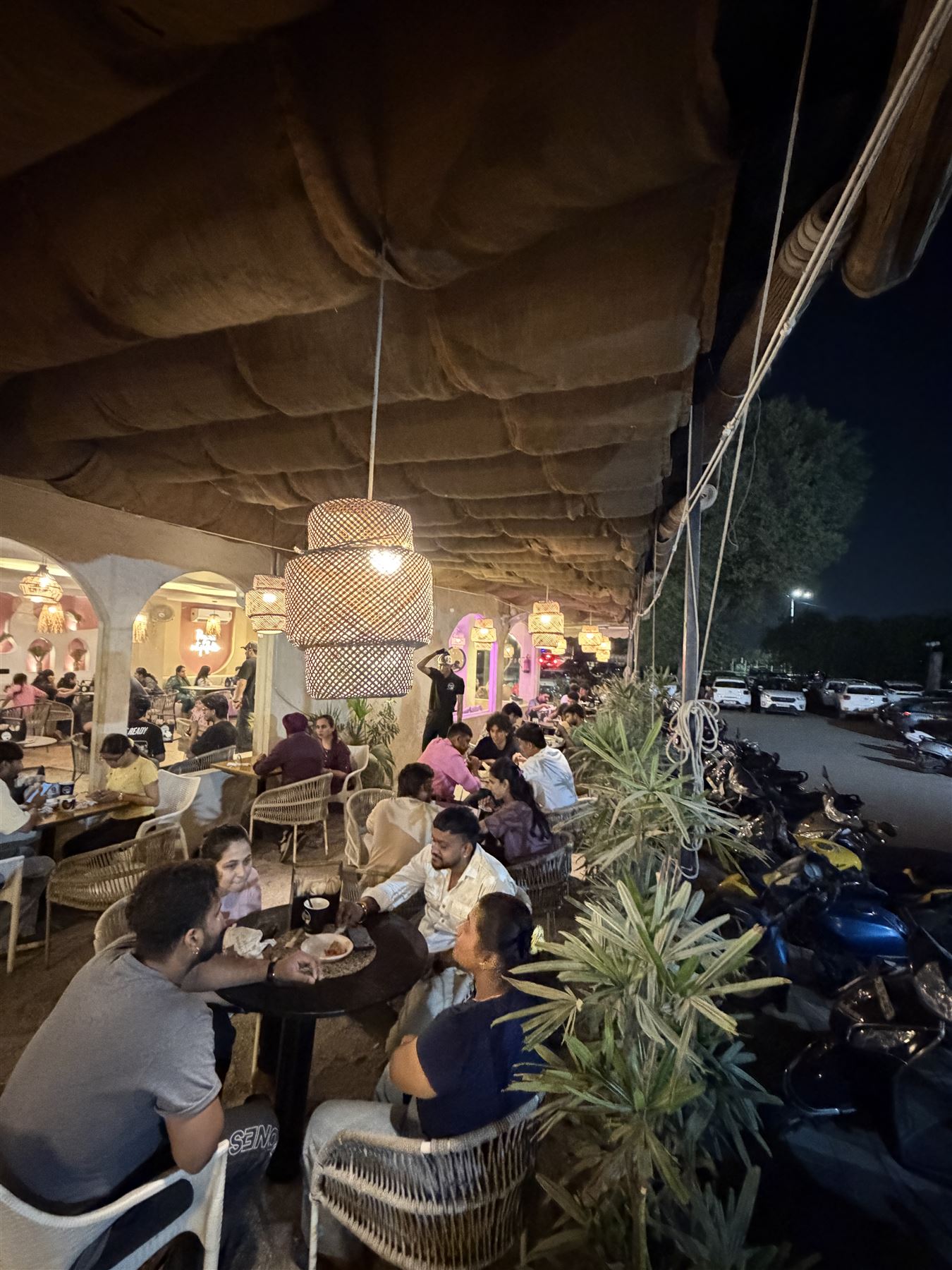 A full terrace of guests at night
